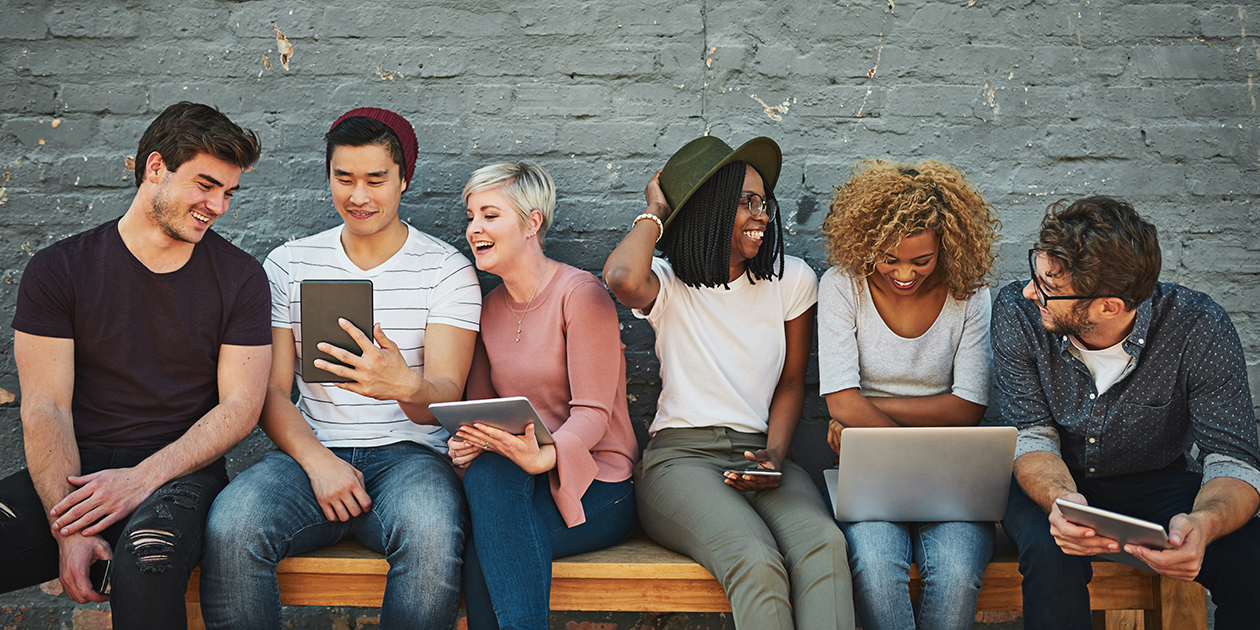 diverse group of people using multiple devices